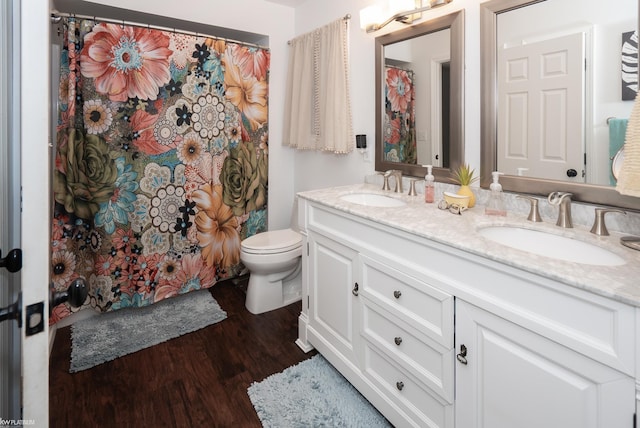 bathroom featuring toilet, vanity, hardwood / wood-style flooring, and curtained shower