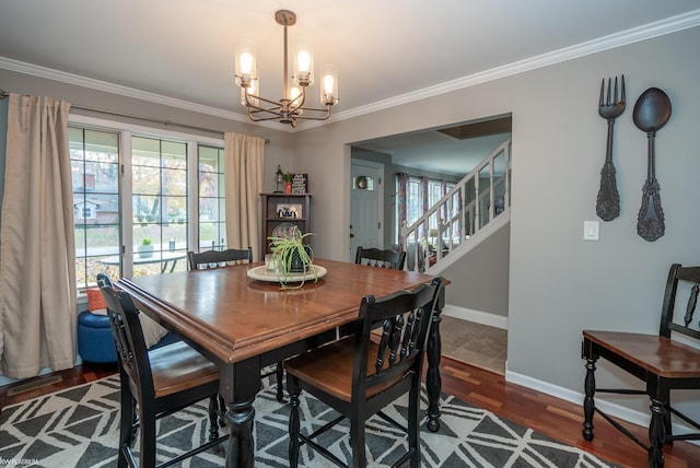 dining space with dark wood-type flooring, a notable chandelier, and ornamental molding