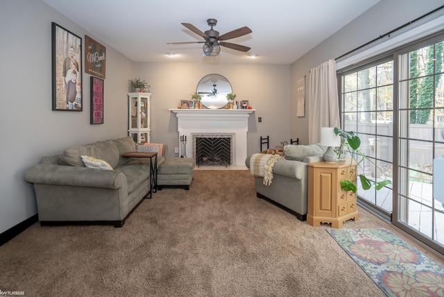 living room with a wealth of natural light, ceiling fan, and carpet floors