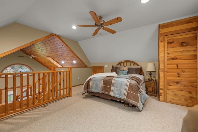 carpeted bedroom with ceiling fan and vaulted ceiling