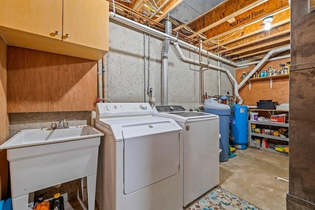 laundry room featuring sink, independent washer and dryer, and cabinets