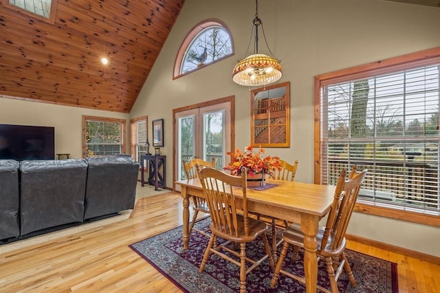 dining area featuring a wealth of natural light, wood-type flooring, and high vaulted ceiling