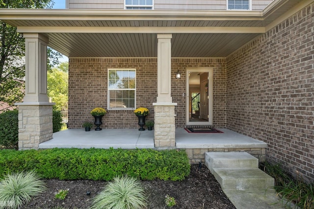 view of exterior entry with a porch