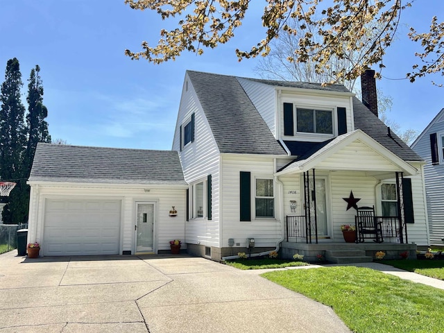 view of front of house with a front yard, covered porch, and a garage