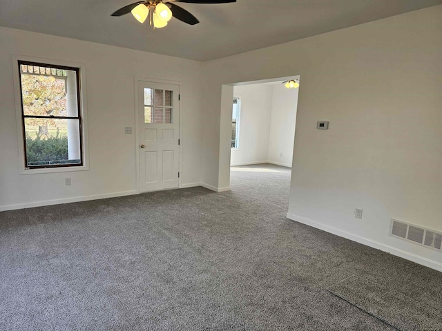 carpeted spare room with ceiling fan