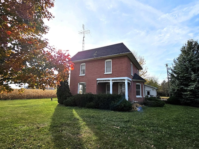 back of property with a lawn