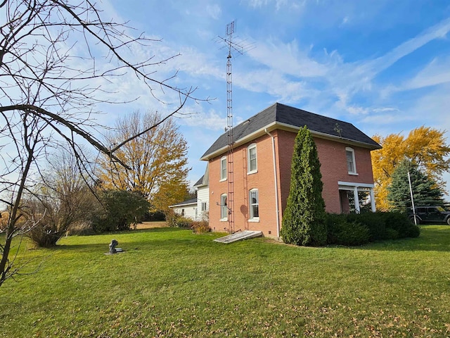 view of side of home with a lawn