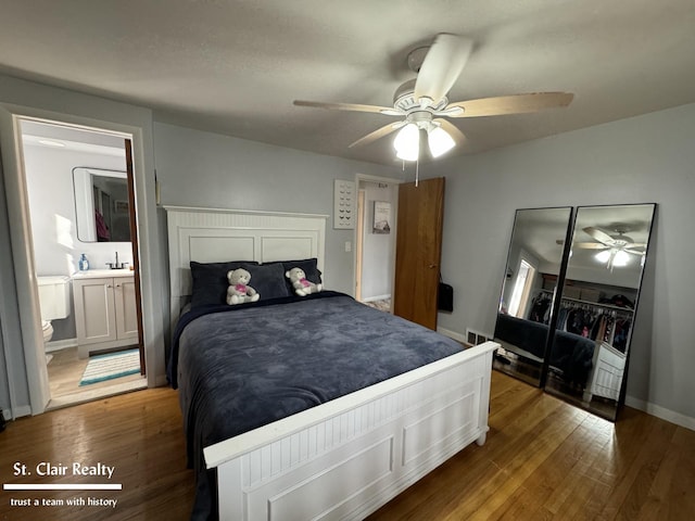 bedroom featuring ceiling fan, wood-type flooring, and connected bathroom