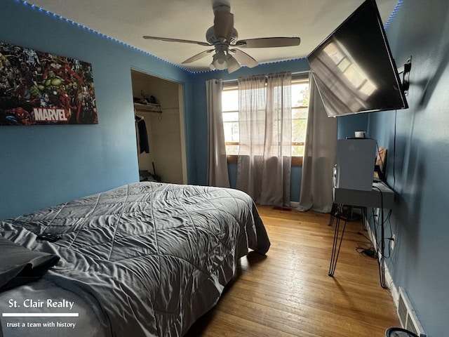 bedroom with wood-type flooring, a closet, and ceiling fan