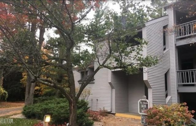 view of side of home with a balcony