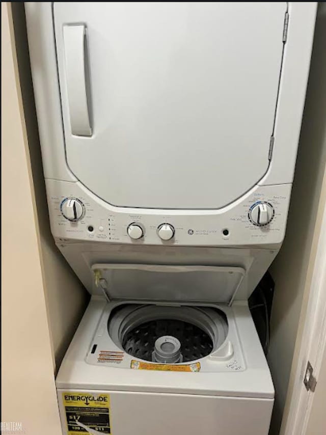 clothes washing area with stacked washer / drying machine