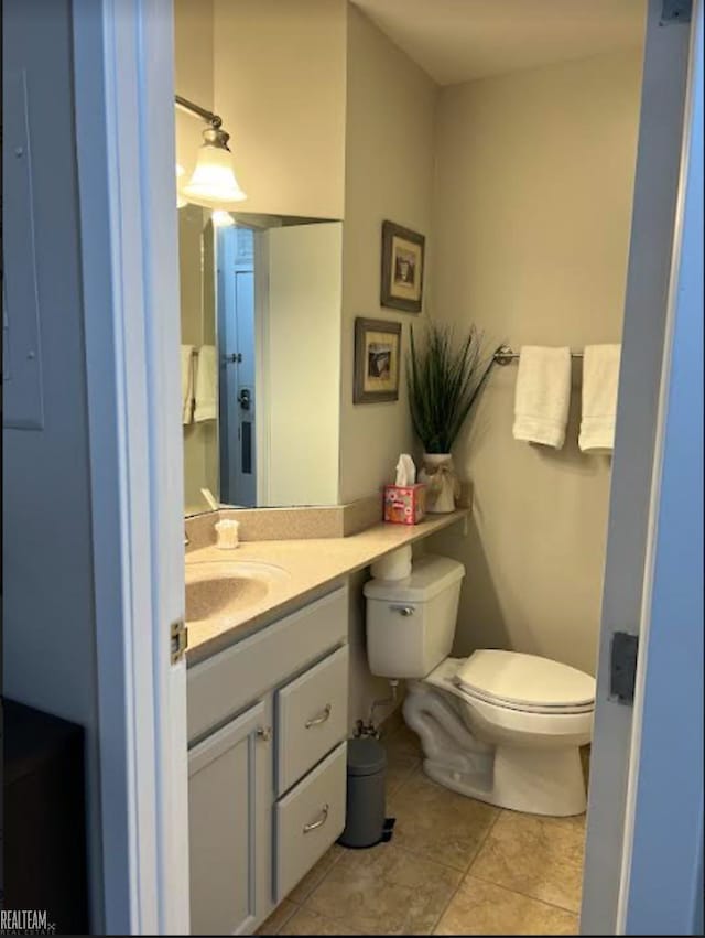 bathroom featuring vanity, toilet, and tile patterned floors