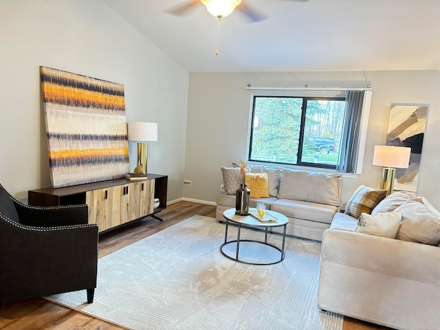 living room featuring hardwood / wood-style floors, vaulted ceiling, and ceiling fan