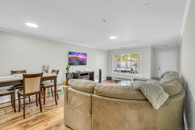 living room with crown molding and light wood-type flooring