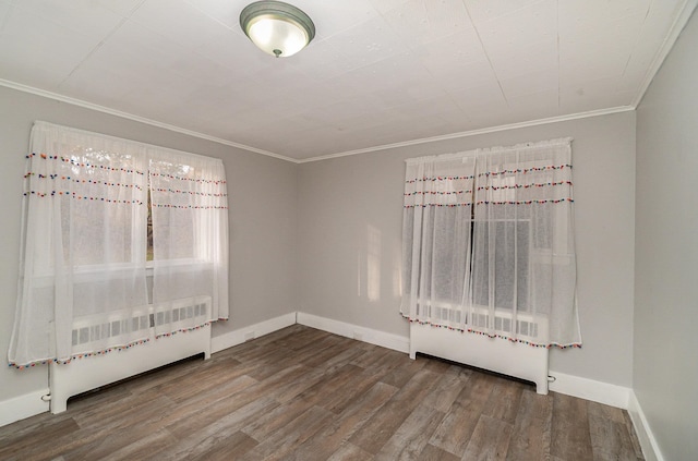 spare room featuring ornamental molding and wood-type flooring