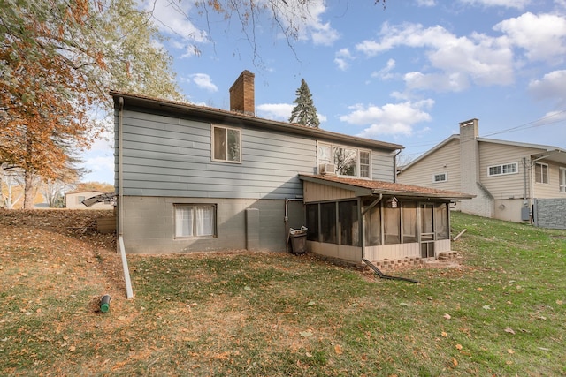 rear view of property featuring a lawn and a sunroom