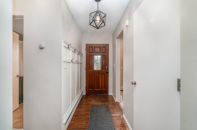 entryway with a chandelier, baseboard heating, and dark hardwood / wood-style floors