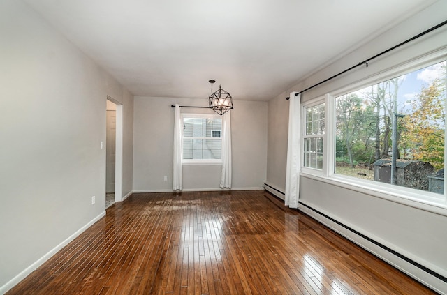 unfurnished dining area featuring a chandelier, a baseboard heating unit, and dark hardwood / wood-style floors