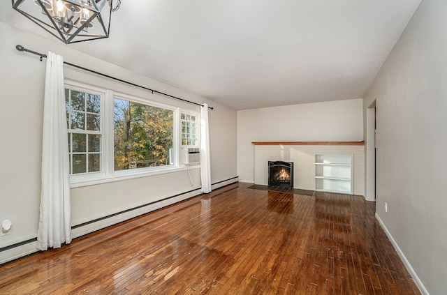 unfurnished living room with hardwood / wood-style flooring and an inviting chandelier