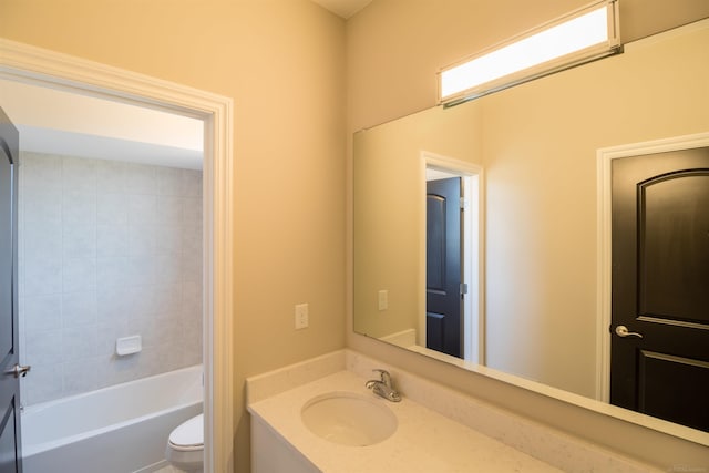 full bathroom with tiled shower / bath, vanity, and toilet