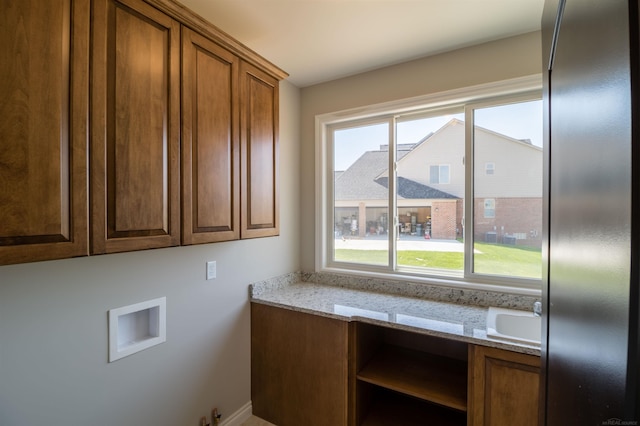 laundry room featuring hookup for a washing machine, cabinets, a wealth of natural light, and sink