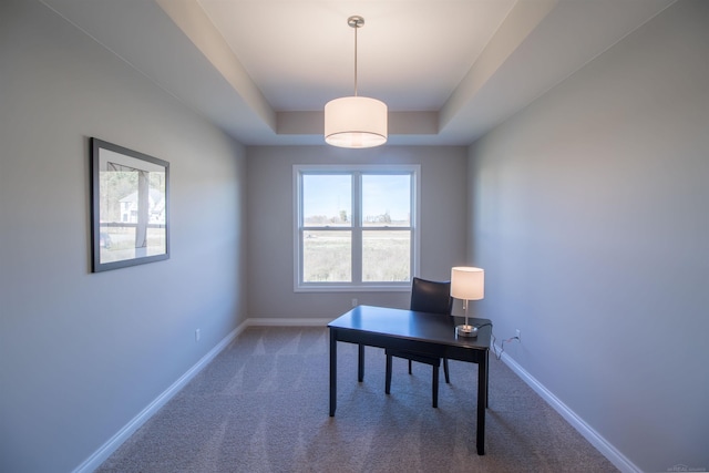 carpeted office with a raised ceiling