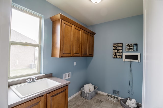 washroom featuring cabinets, sink, and washer hookup