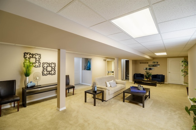 carpeted living room with a paneled ceiling