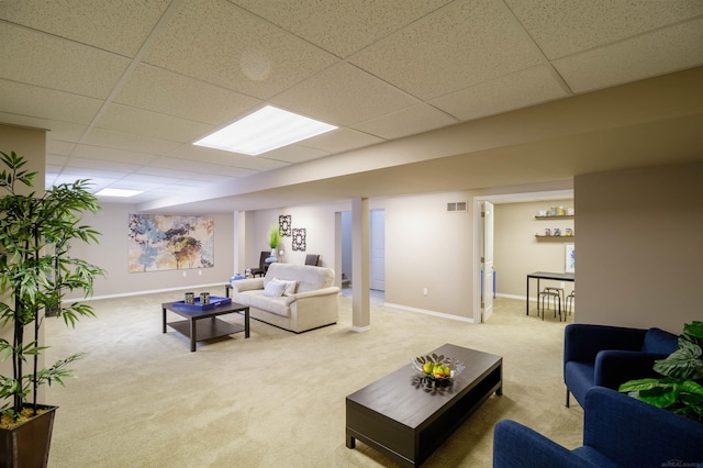 living room with a paneled ceiling and carpet flooring