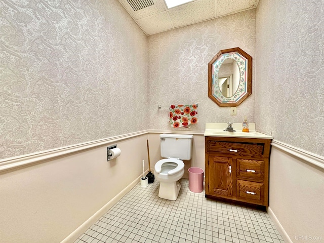 bathroom with toilet, vanity, and tile patterned floors