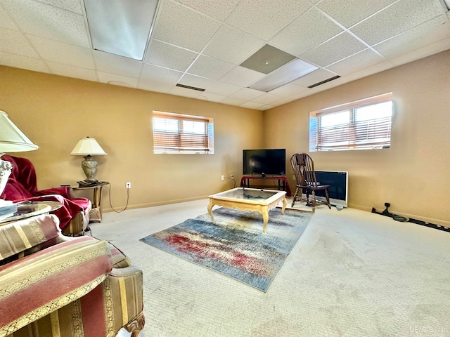 carpeted living room featuring a paneled ceiling