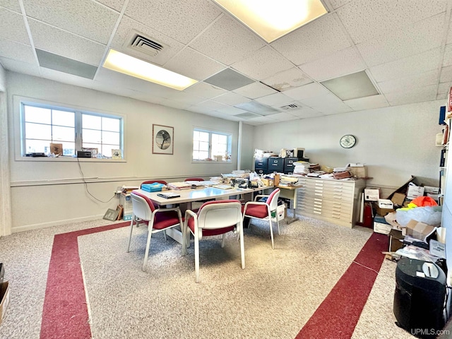 dining room featuring a drop ceiling and carpet flooring