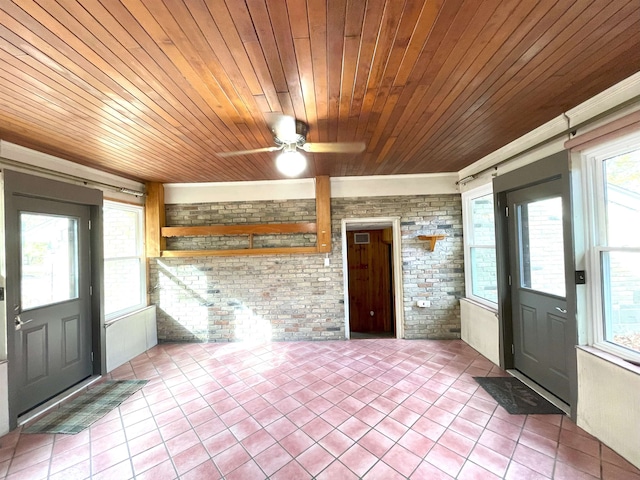 unfurnished sunroom featuring ceiling fan and wooden ceiling