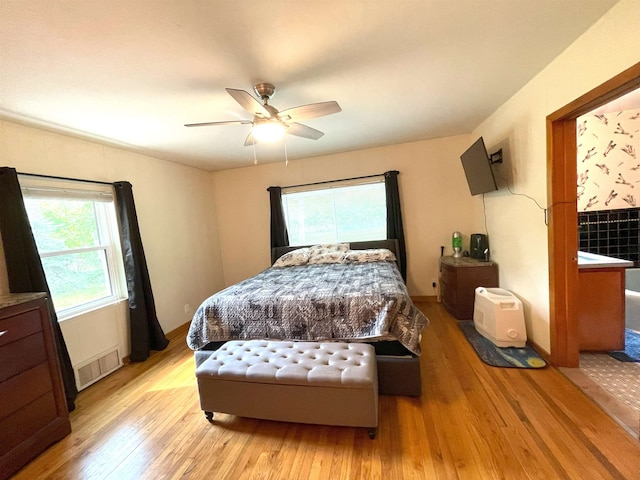 bedroom with ceiling fan and light wood-type flooring