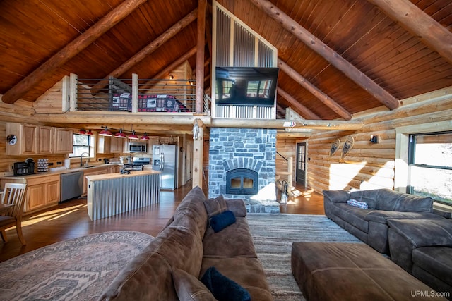 living room with hardwood / wood-style flooring, wood ceiling, a stone fireplace, and beam ceiling