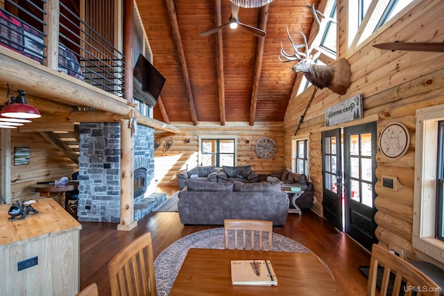 living room featuring beam ceiling, wooden ceiling, dark hardwood / wood-style floors, rustic walls, and french doors