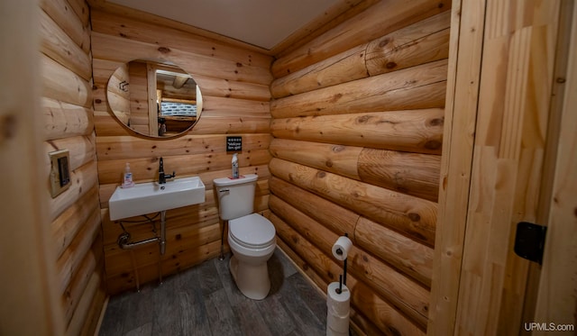 bathroom featuring sink, wood-type flooring, and toilet