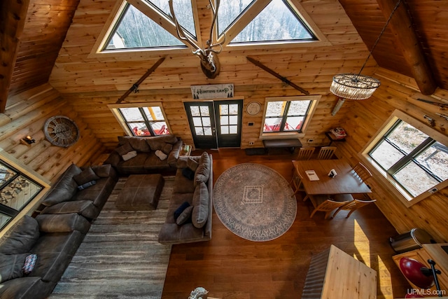 unfurnished living room featuring high vaulted ceiling and plenty of natural light