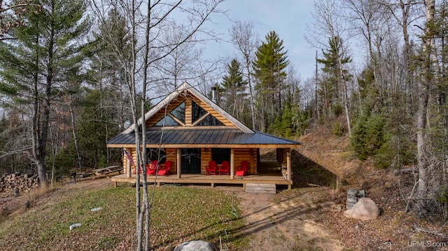 log cabin with a wooden deck