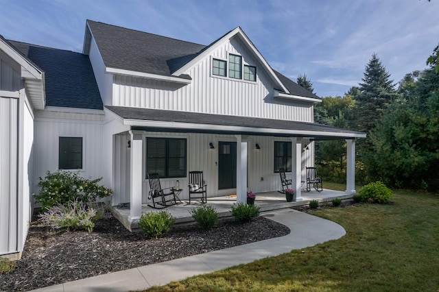 exterior space with a porch and a lawn