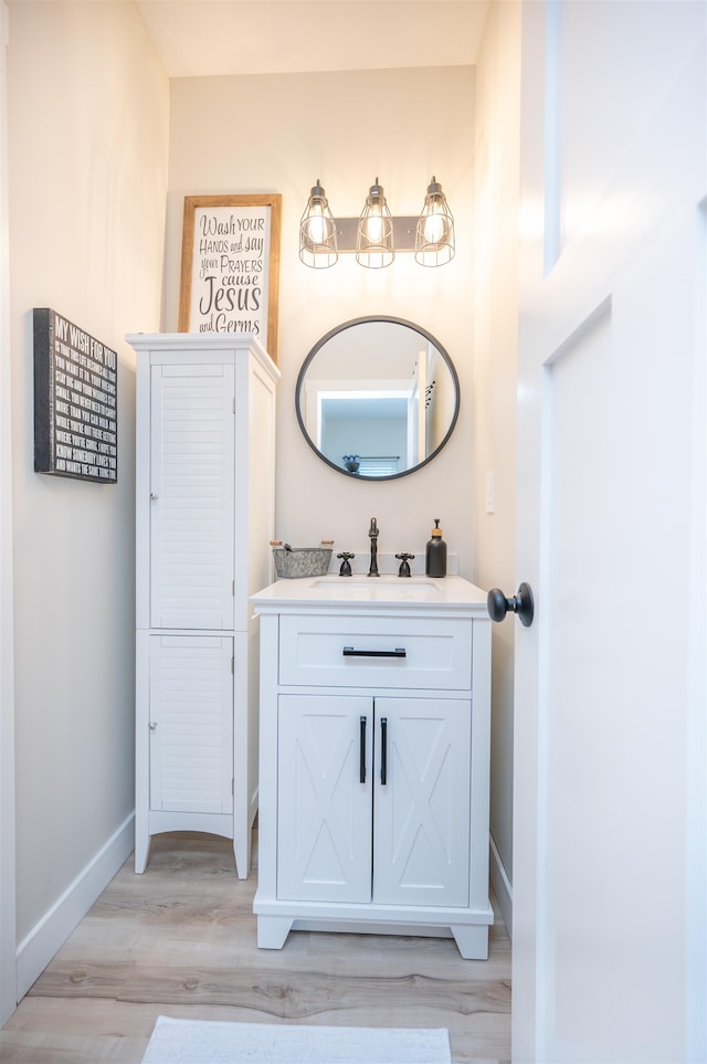 bathroom with vanity and wood-type flooring