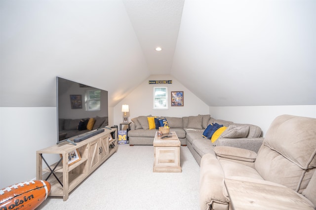 carpeted living room with vaulted ceiling