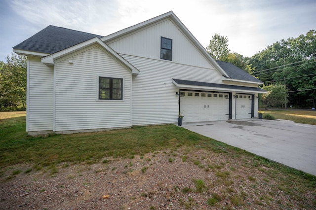 view of home's exterior with a garage and a lawn