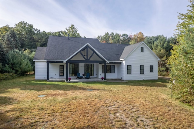 view of front of home with a patio and a front yard