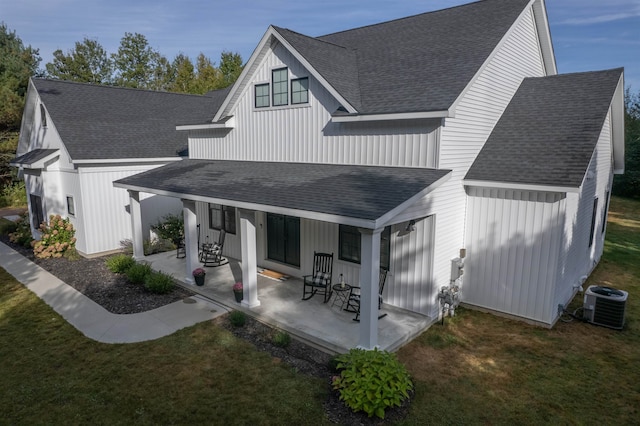 back of house featuring a yard, central AC unit, and a porch