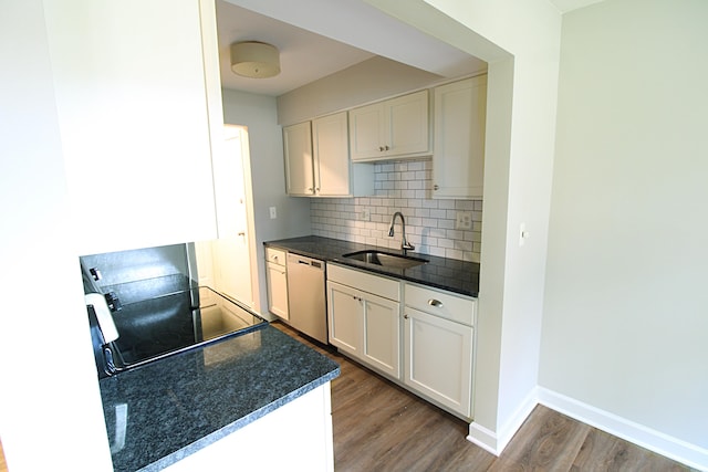 kitchen with sink, light wood-type flooring, backsplash, white cabinetry, and stainless steel dishwasher