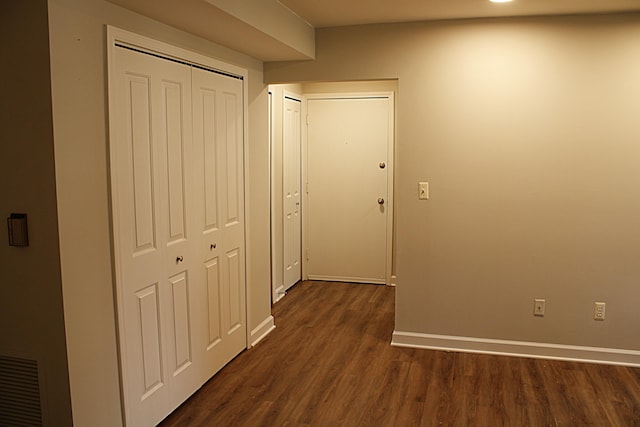 corridor featuring dark hardwood / wood-style floors