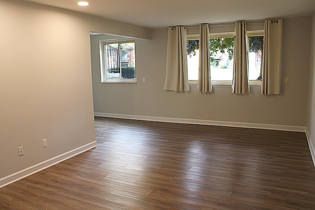 spare room featuring dark hardwood / wood-style floors