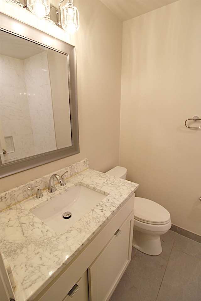 bathroom featuring vanity, toilet, and tile patterned flooring