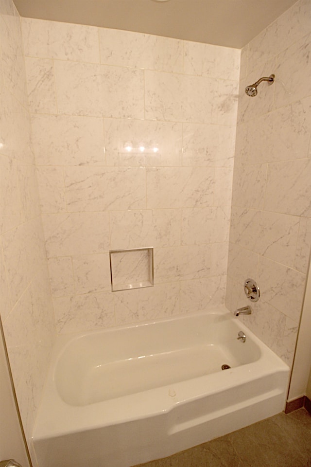 bathroom featuring tiled shower / bath combo and tile patterned floors